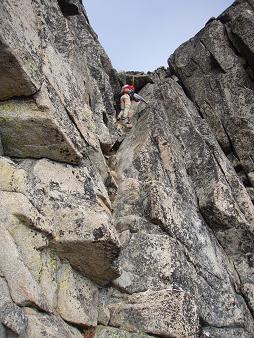 Descending the crux gully, Carla is right below the 4th class move