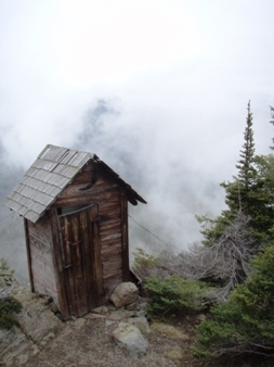 Precariously perched outhouse on the summit
