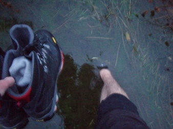 Wading through the marsh with my boots in my hands