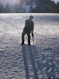 Dad glissading icy snow.